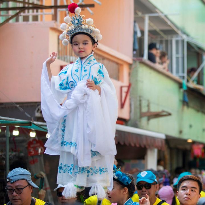 Cheung Chau Bun Festival, Piu Sik Parade little girl wearing a deity costume supported up on wooden stilts
